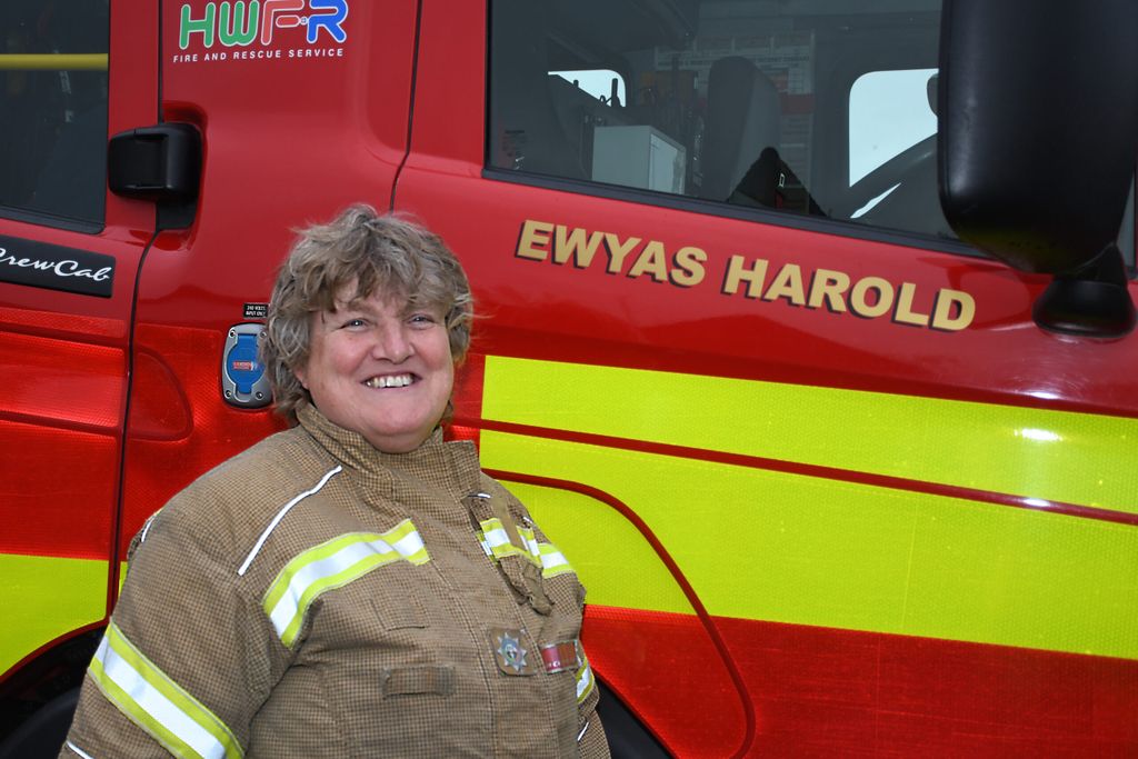 Firefighter standing in front of a fire engine