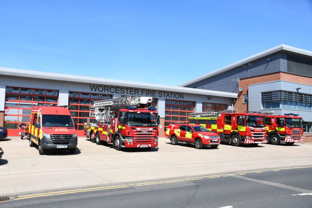 Line up of fire vehicles in front of fire station