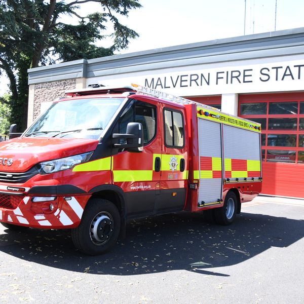 Compact fire engine in front of fire station