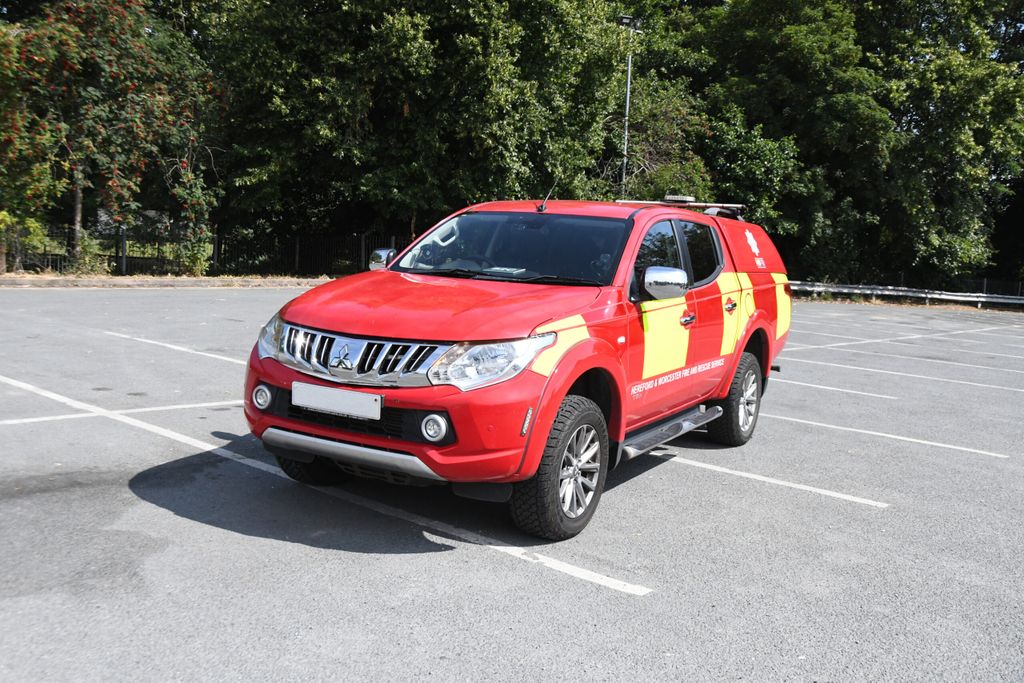 crew carrier in car park with green trees as backdrop