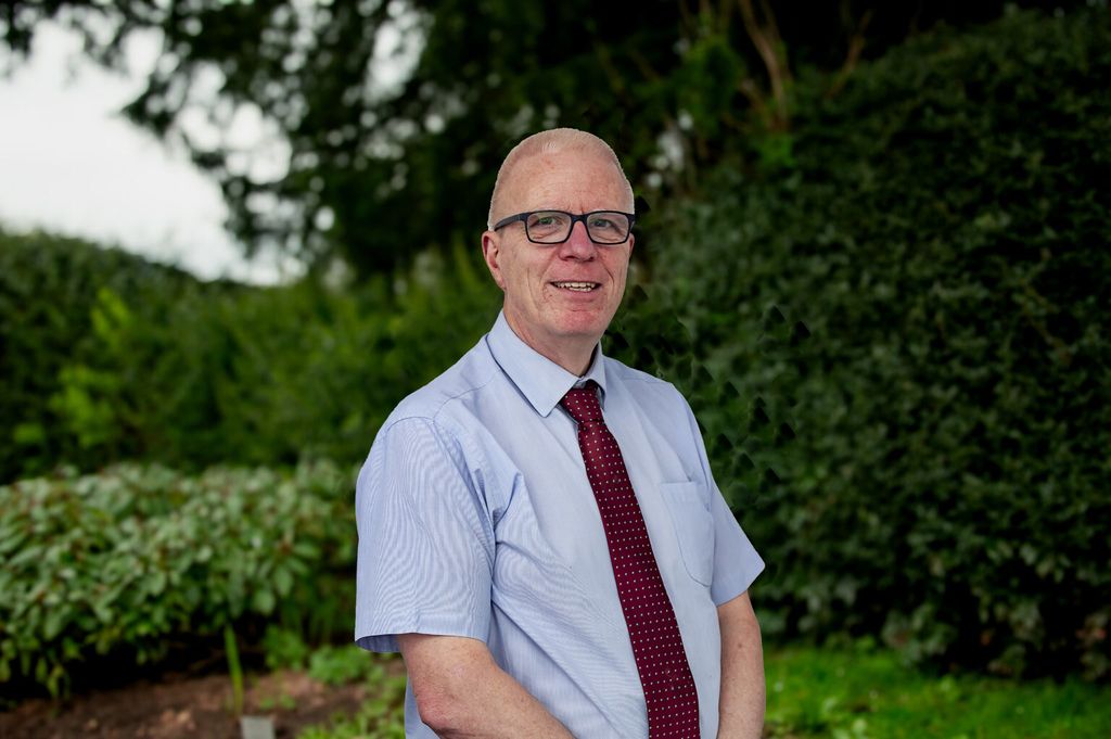 Finance director in front of trees