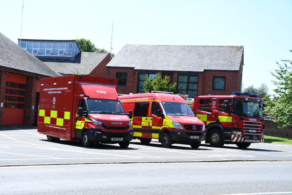 Three fire vehicles in front of fire station