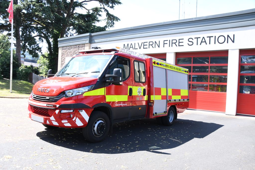 Compact fire engine in front of fire station