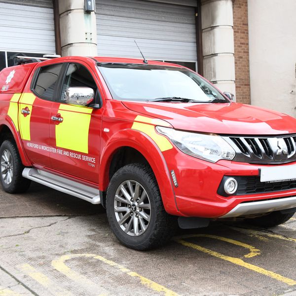 crew carrier pictured in front of fire station bay