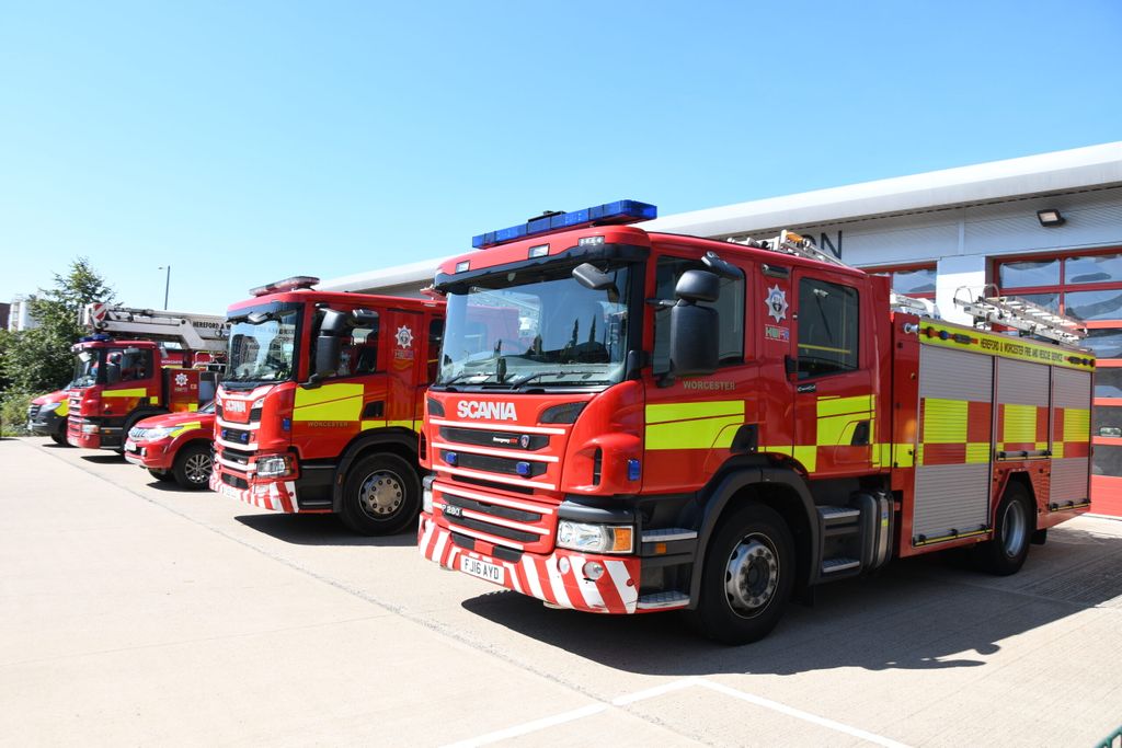 Fire engine in foreground with other vehicles in line