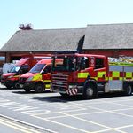 Three fire vehicles with fire engine in foreground