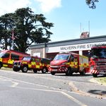 Line up of fire vehicles with fire engine in foreground