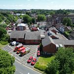 Drone shot of fire station with fire vehicles at front