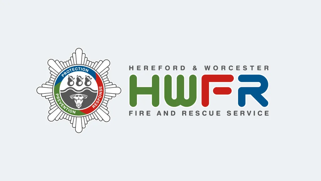 The Hereford and Worcester Fire and Rescue Service logo which depicts the fire service crest with the words Protection, Response and Prevention in a circle, three pears, a river and a bull to depict the two counties. Hereford and Worcester Fire and Rescue Service is spelt out along with the letters HWFR.