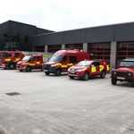 6 vehicles at front of station, Land Rover in foreground