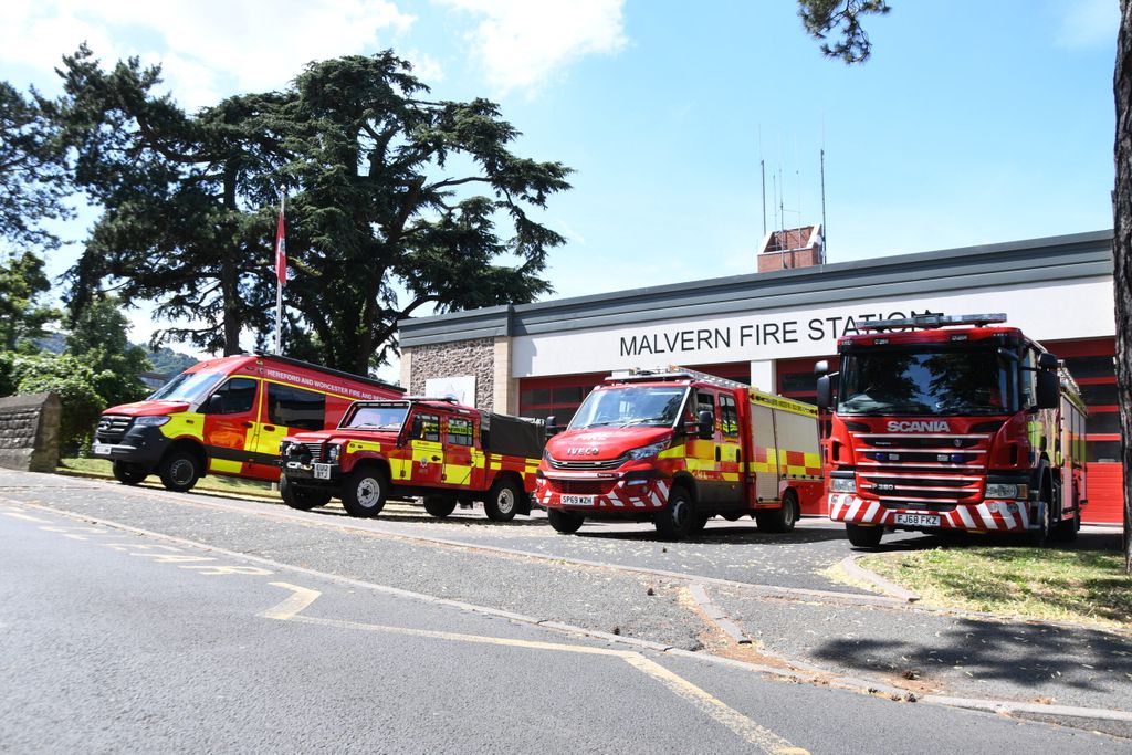 Line up of fire vehicles with fire engine in foreground