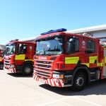 Fire engine in foreground with other vehicles in line