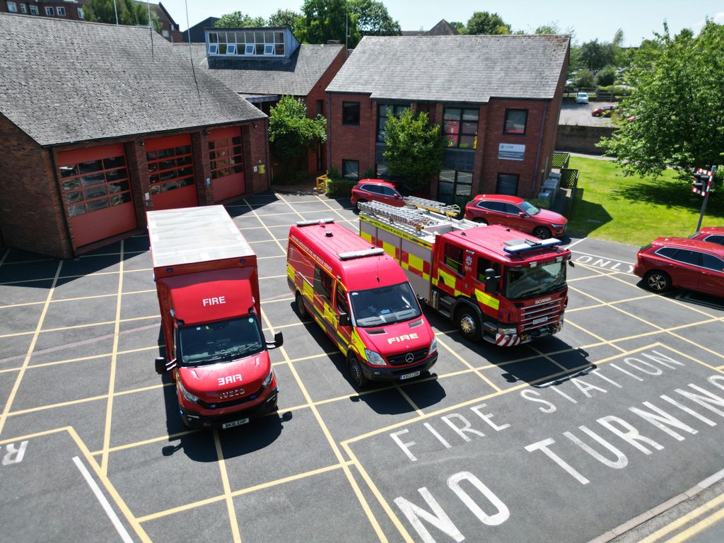 Three fire vehicles in front of fire station taken from above