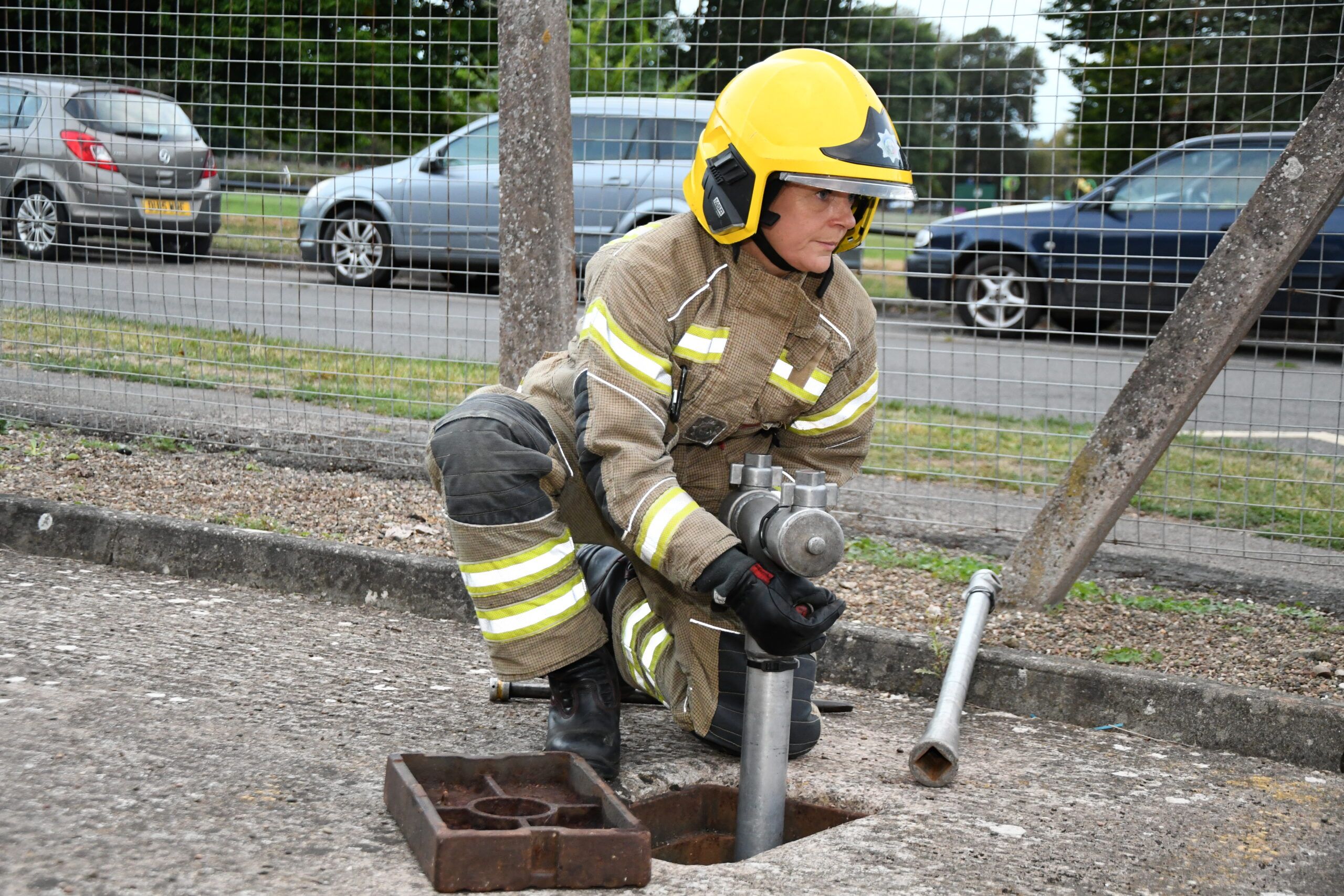 Female firefighter unlocking fire hydrant