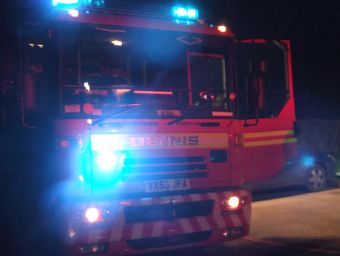 Fire engine in the dark with blue lights on