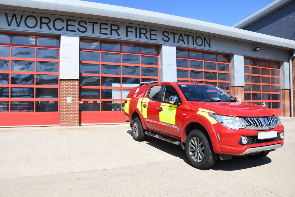 Crew carrier in front of fire station shutter